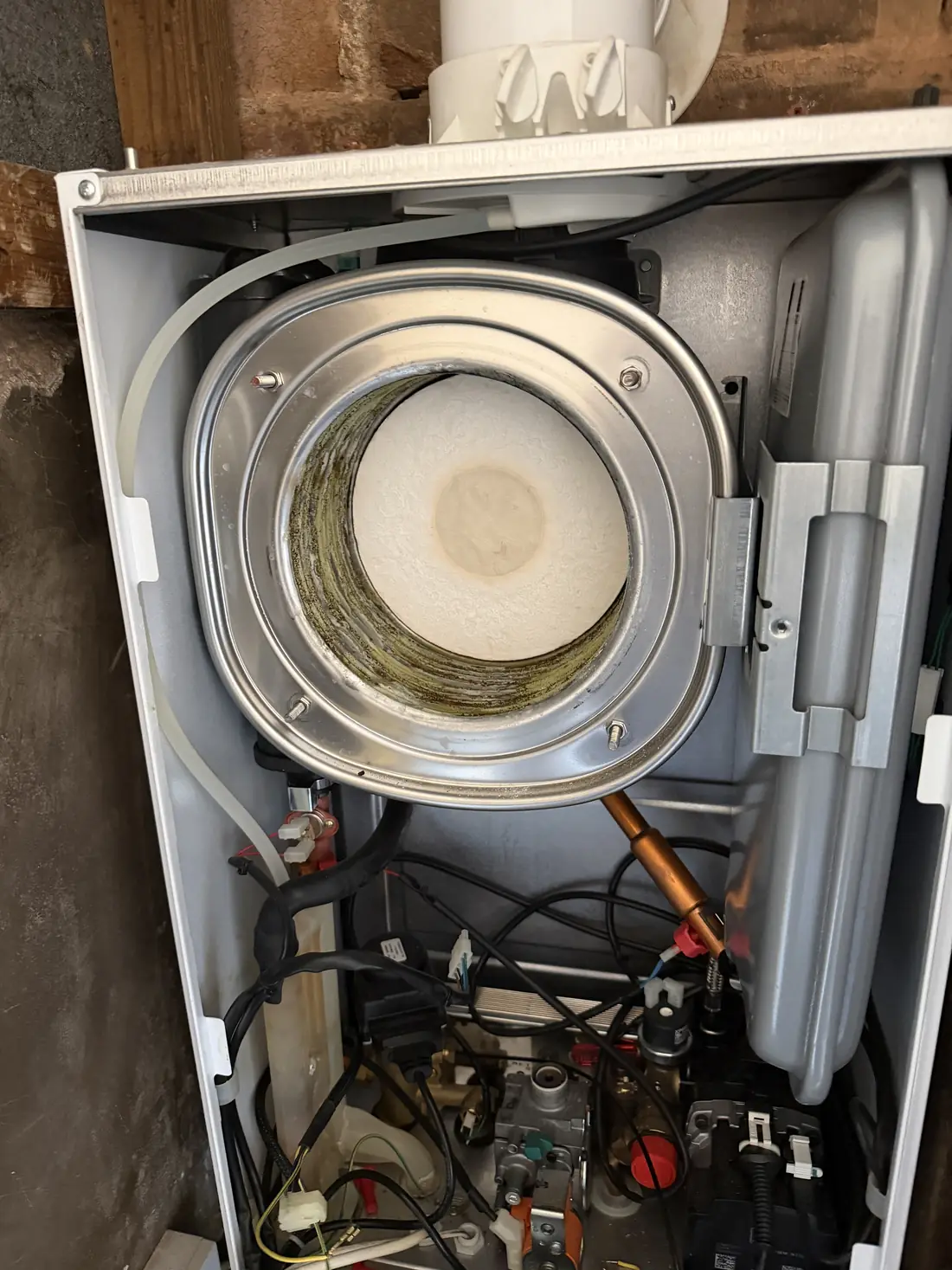 Baxi 800 combustion chamber open with the burner door removed, showing the heat exchanger