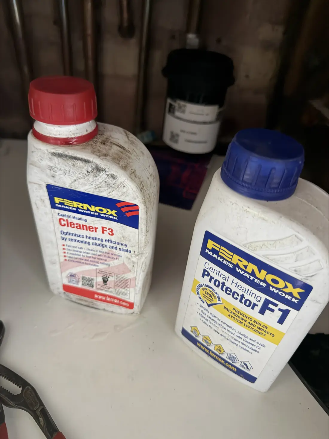 Bottles of Fernox F3 central heating cleaner and Fernox F1 protector used on the system