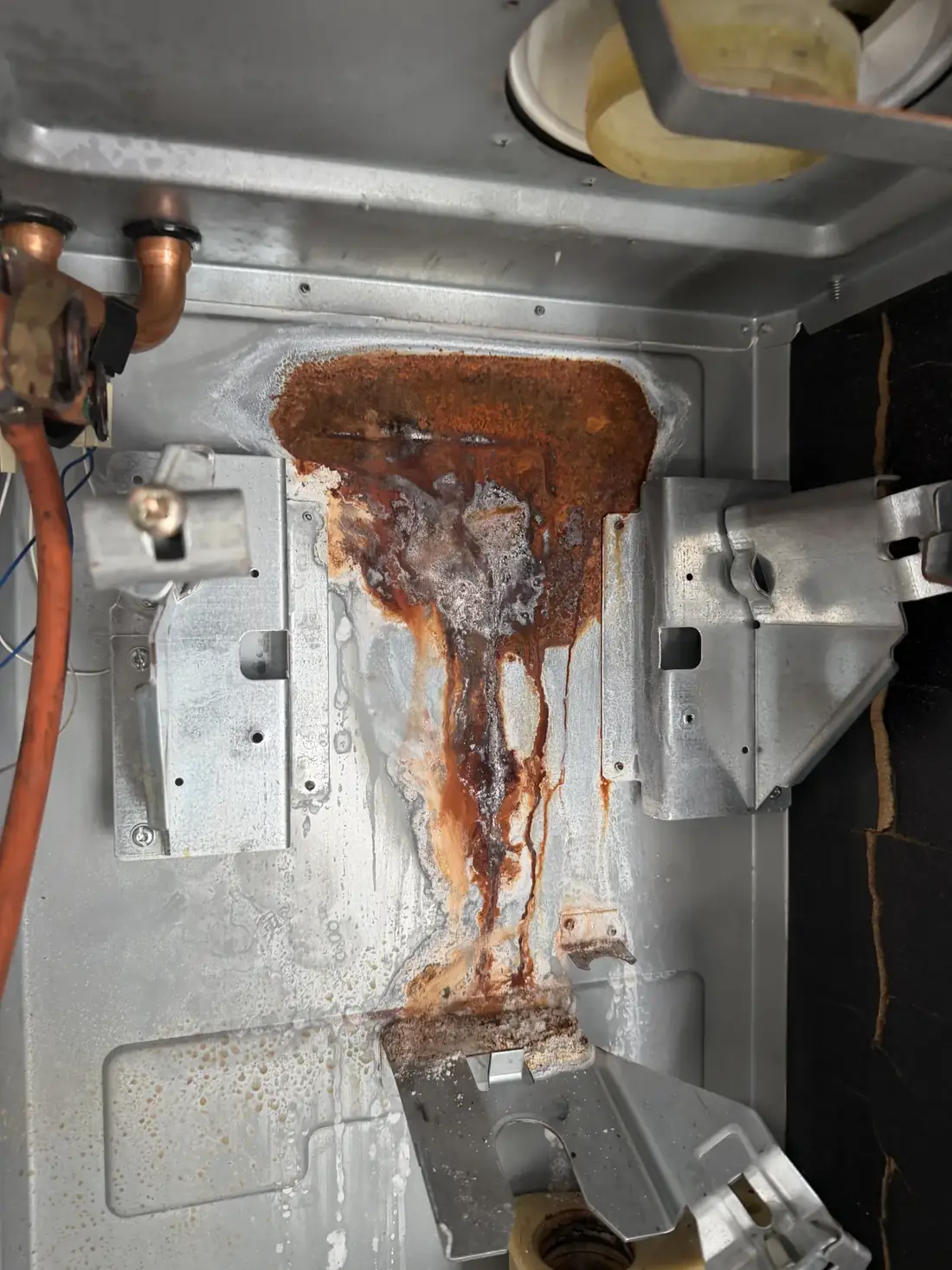 Rust and corrosion on the floor of the Glow-worm boiler case behind the heat exchanger