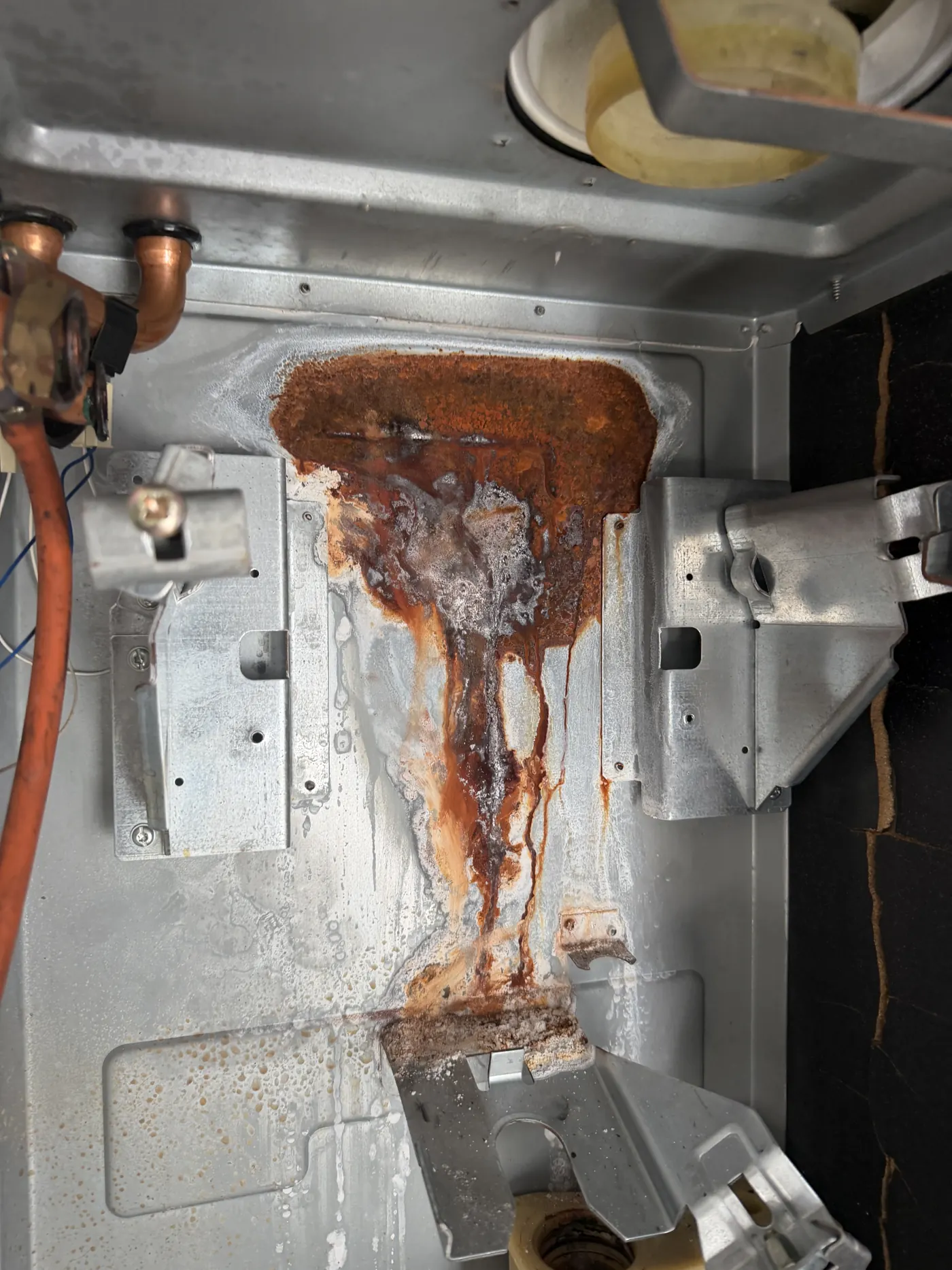 Rust and corrosion on the floor of the Glow-worm boiler case behind the heat exchanger