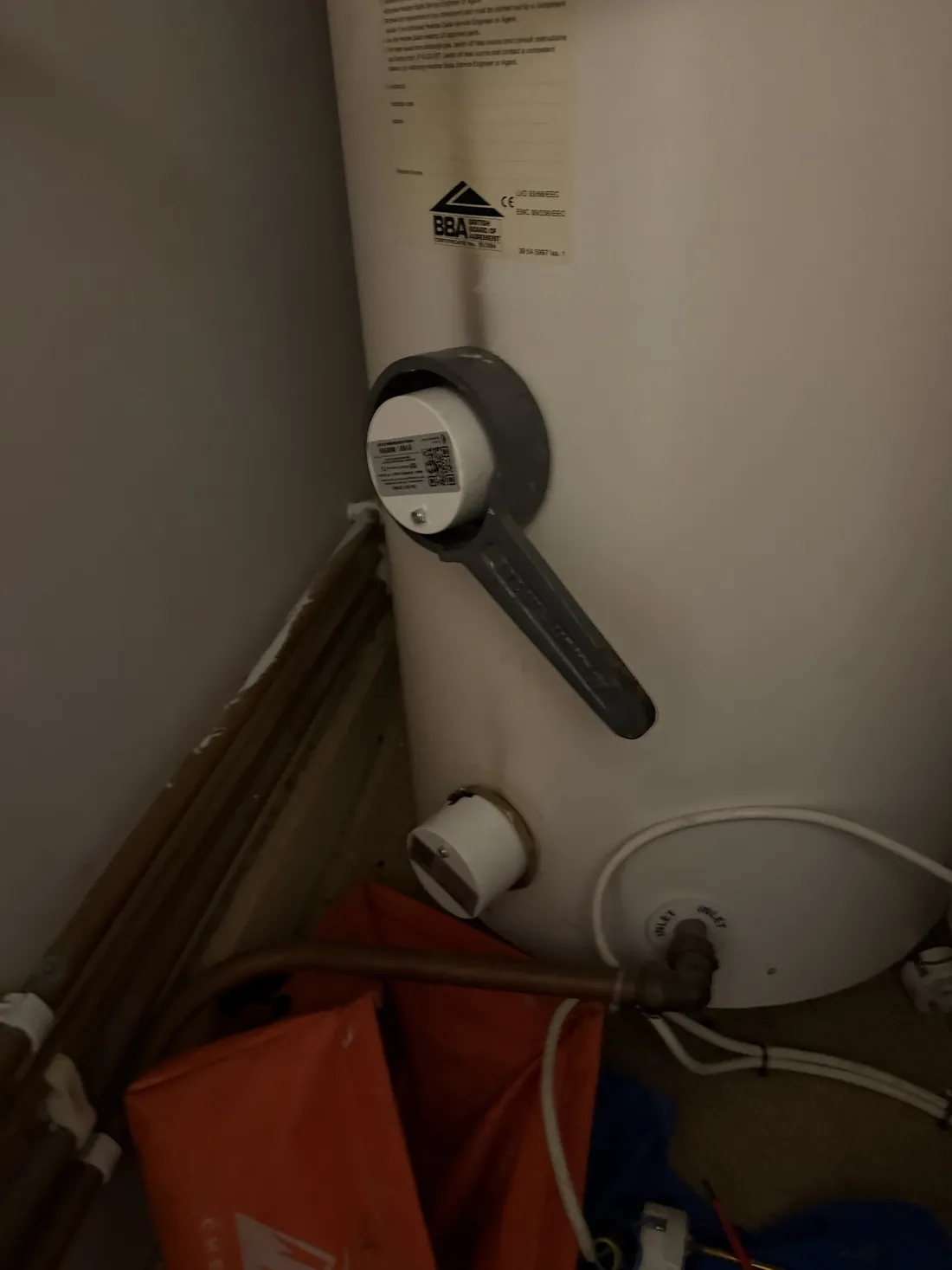 New immersion heater being tightened into a Megaflo cylinder with an immersion spanner