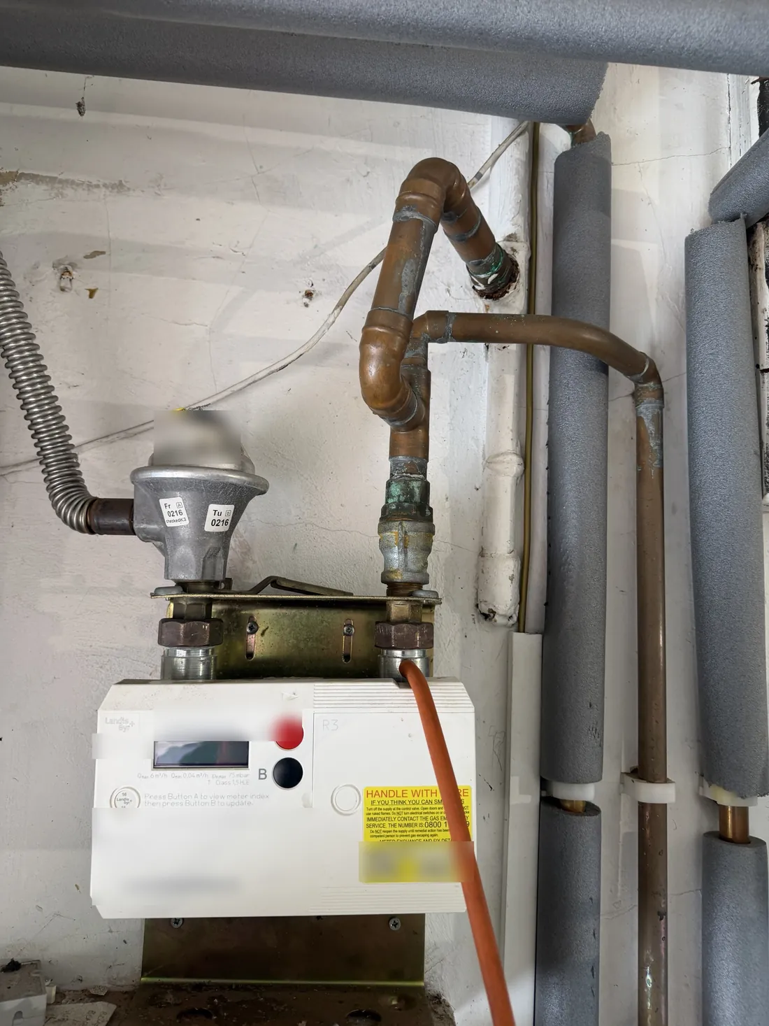 Gas meter in an Edgbaston home with a manometer hose connected for a tightness test after the leak was repaired