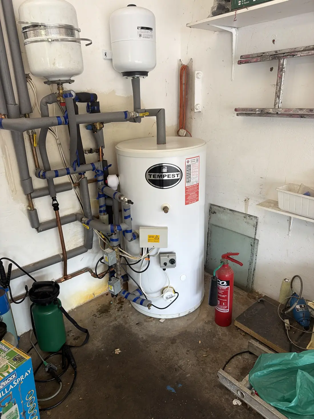 Tempest unvented hot water cylinder with expansion vessel and insulated pipework in the Edgbaston garage