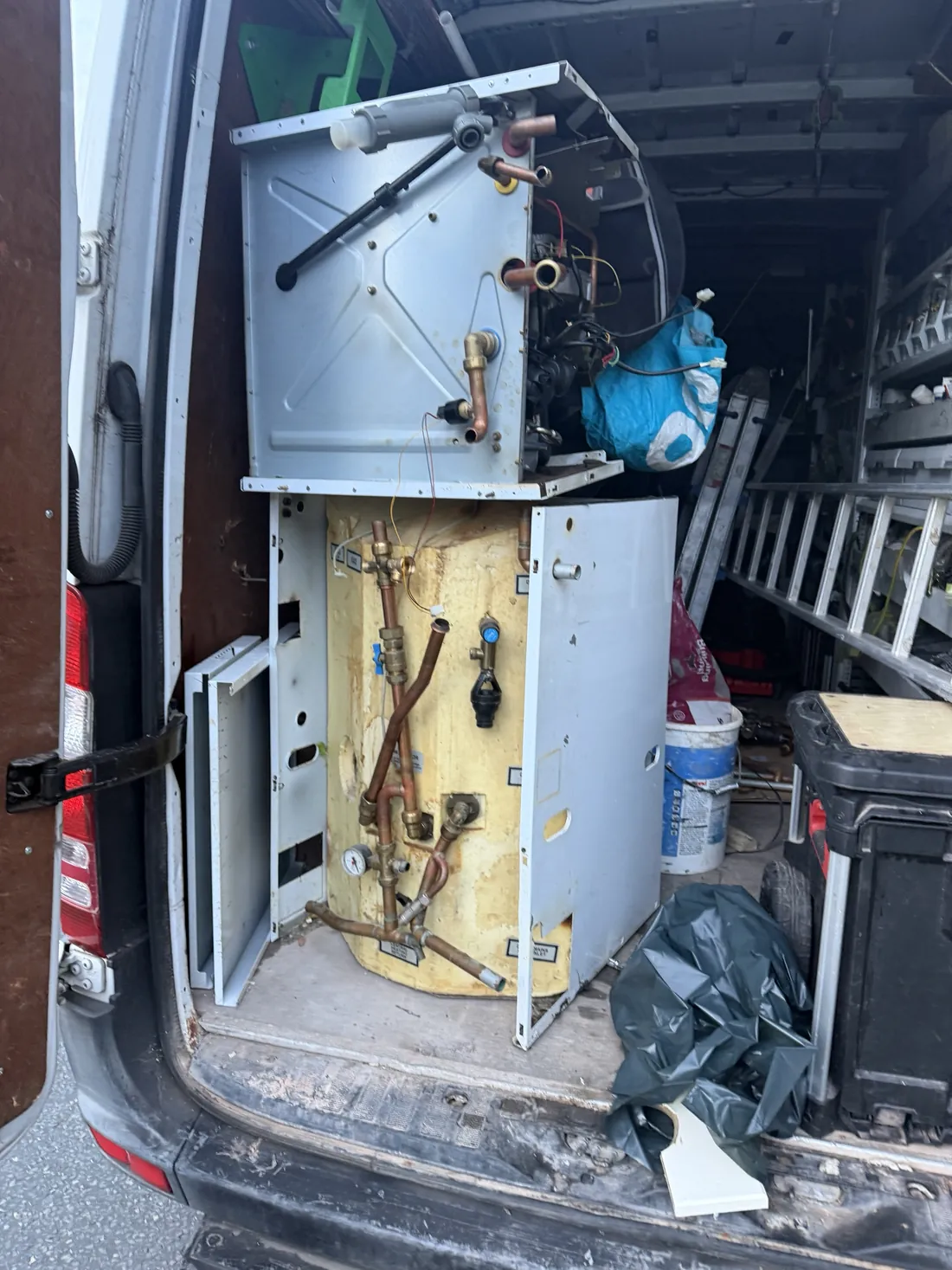 The removed Potterton Powermax boiler and hot water store loaded in the back of a Synergy Gas and Plumbing van