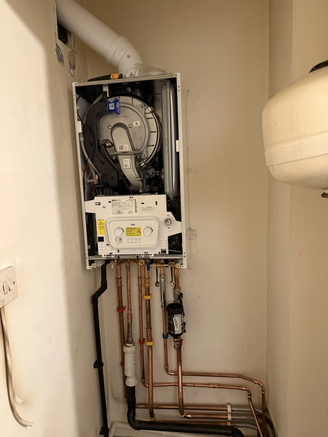 New Baxi 400 combi boiler with the front case off and new copper pipework and a Sentinel magnetic filter below