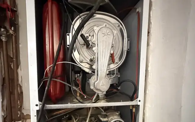 A Potterton Gold combi boiler with its case off in Great Barr