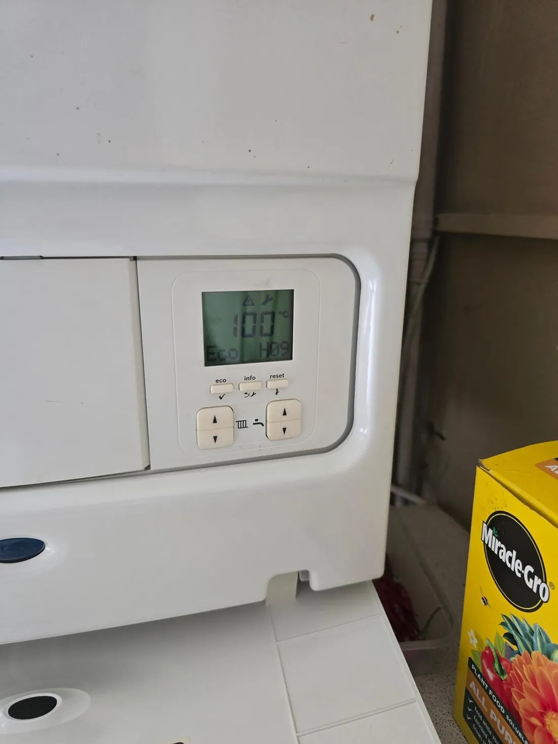 Worcester Greenstar 30i ErP display showing the warning and spanner symbols, a reading of 100 degrees and the fault code H09