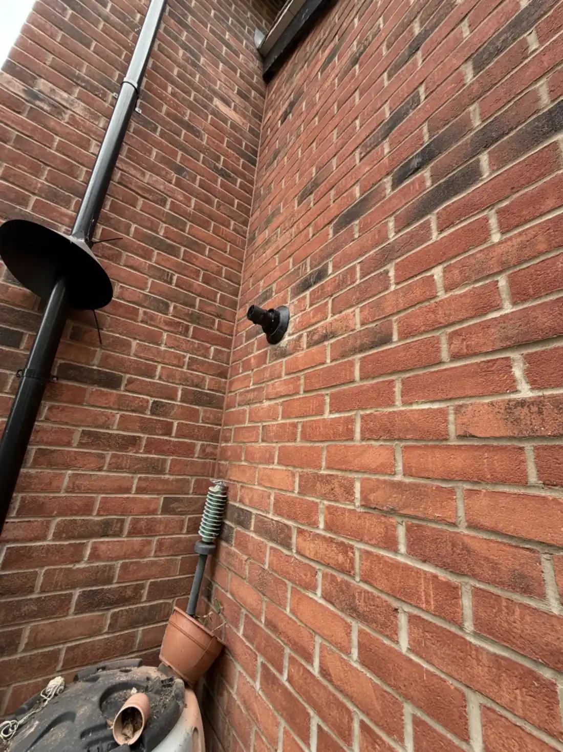 The new boiler flue terminal on an outside brick wall