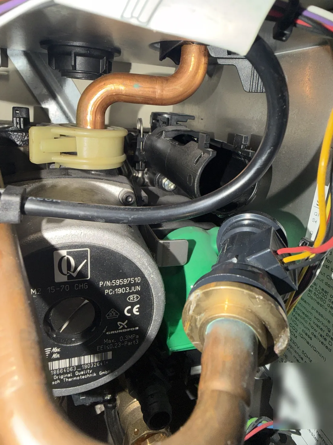 Heating flow pipe and flow adapter pulled out of the right-hand plastic manifold on a Worcester Greenstar boiler