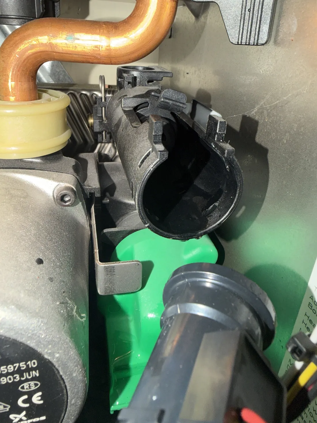 Open connection on the plastic hydraulic manifold of a Worcester Greenstar with the flow adapter removed