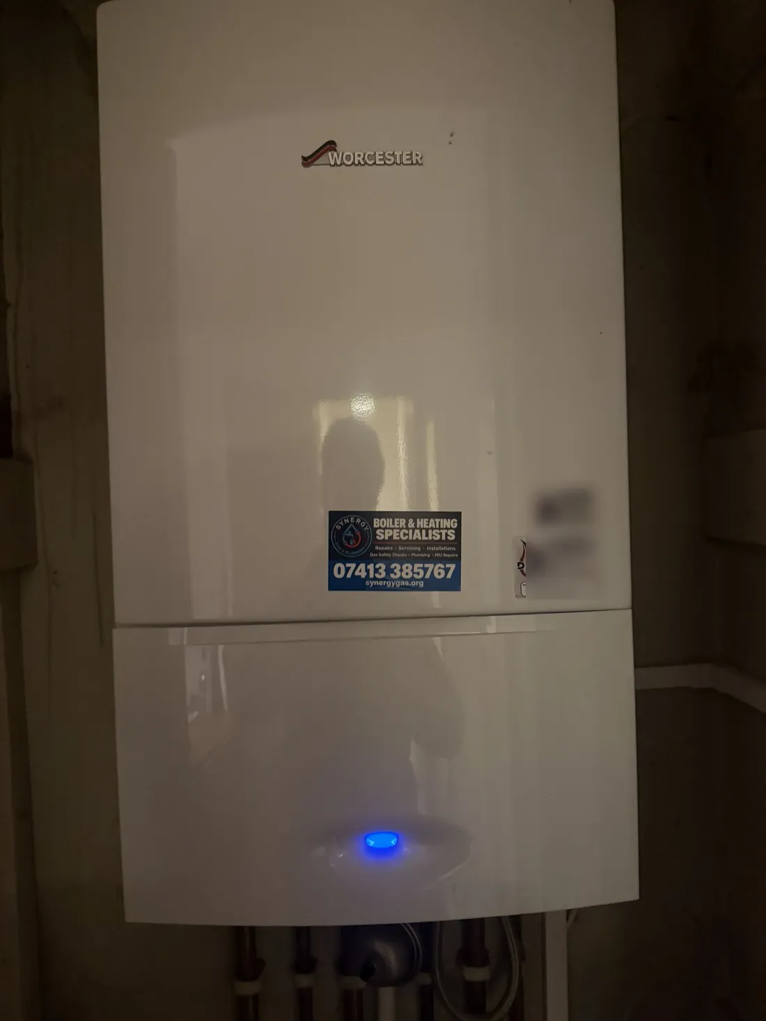 Worcester Greenstar combi boiler with the case back on and the blue power light on after an out-of-hours leak repair