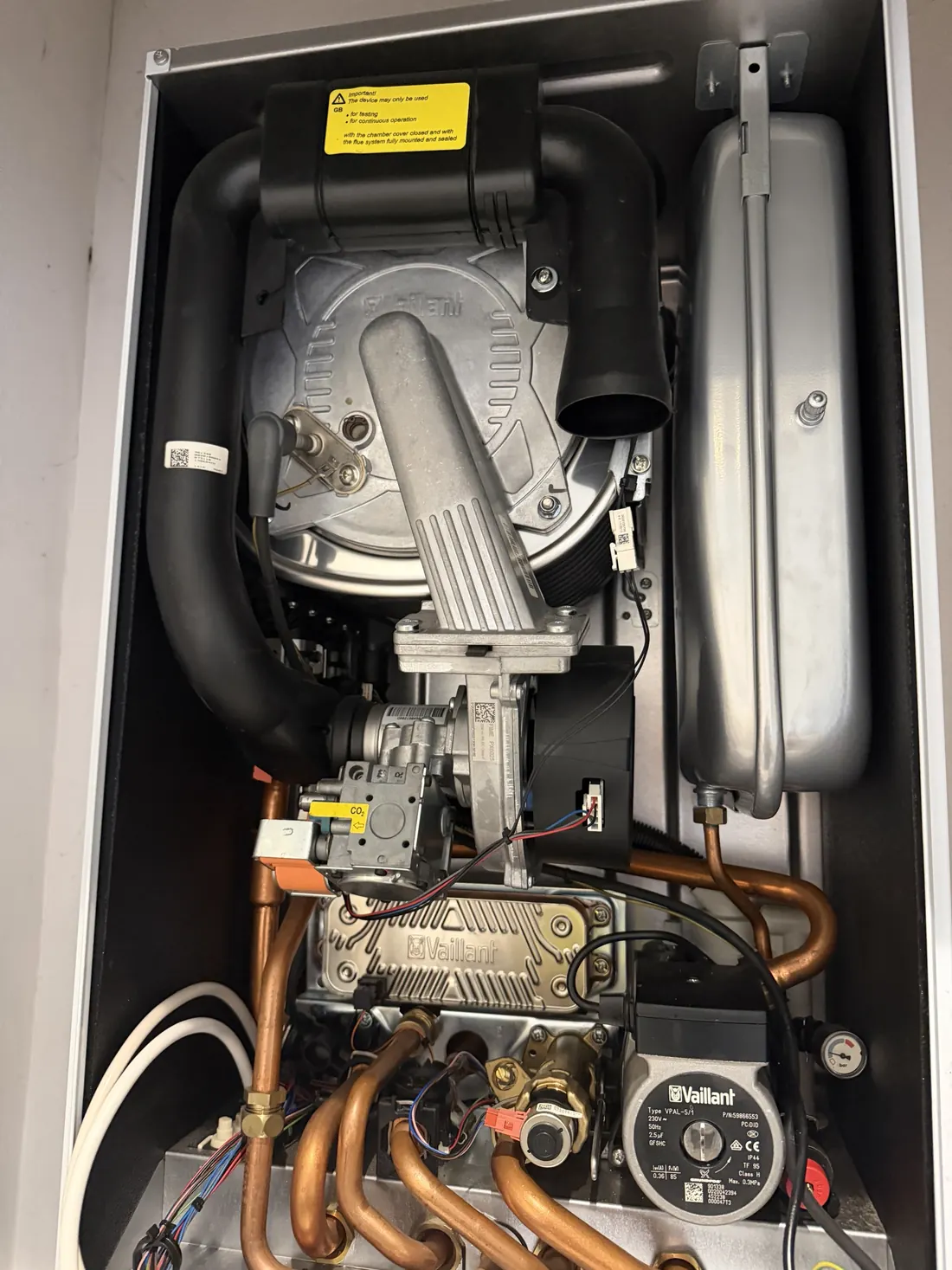 Vaillant ecoTEC pro 28 combi boiler in a Kitts Green airing cupboard with the front case removed for its annual service