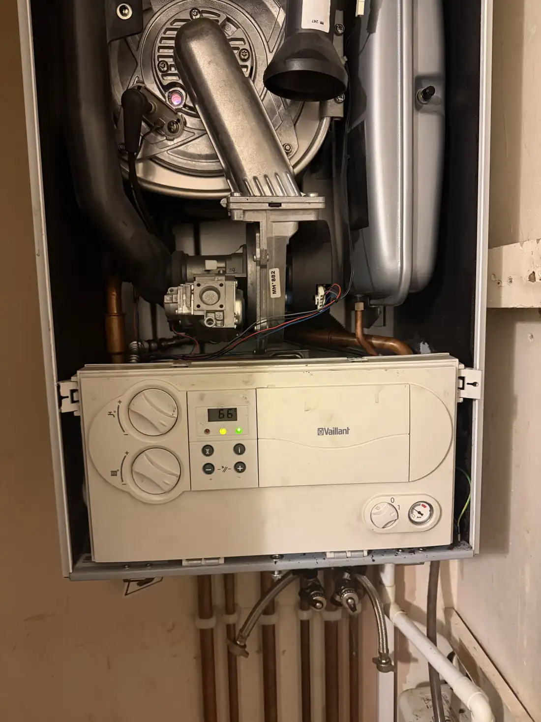 A Vaillant ecoTEC control panel showing 66 degrees with the boiler running again