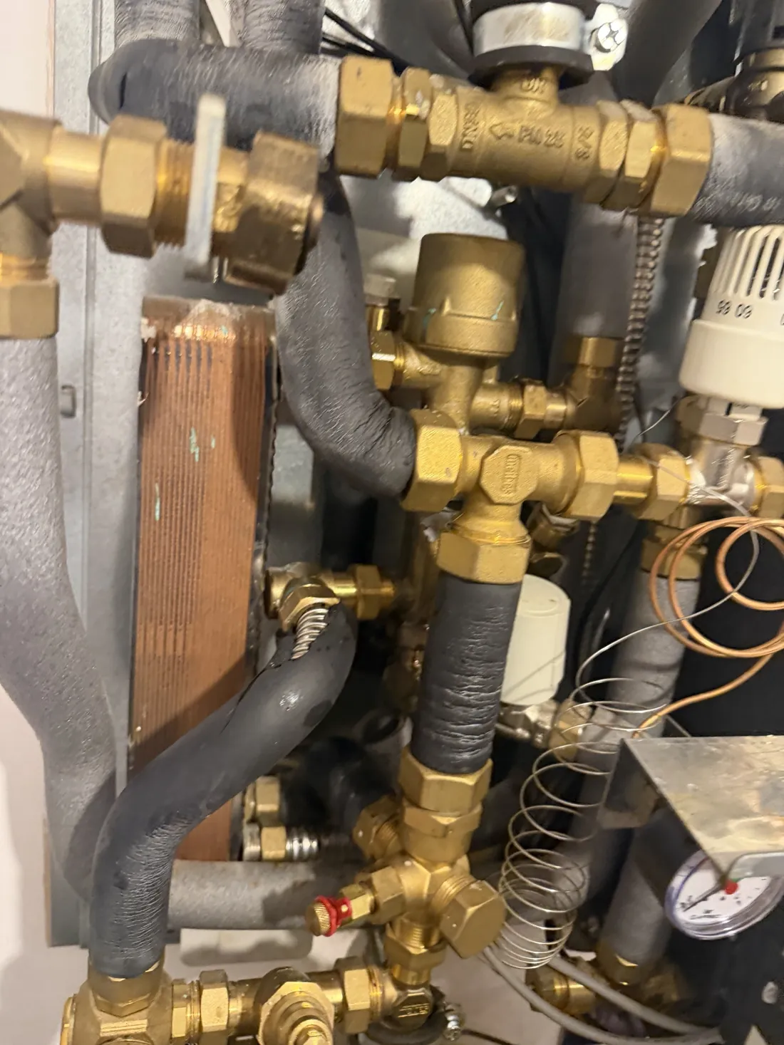 New brass PM valve fitted in a Meibes heat interface unit beside the plate heat exchanger