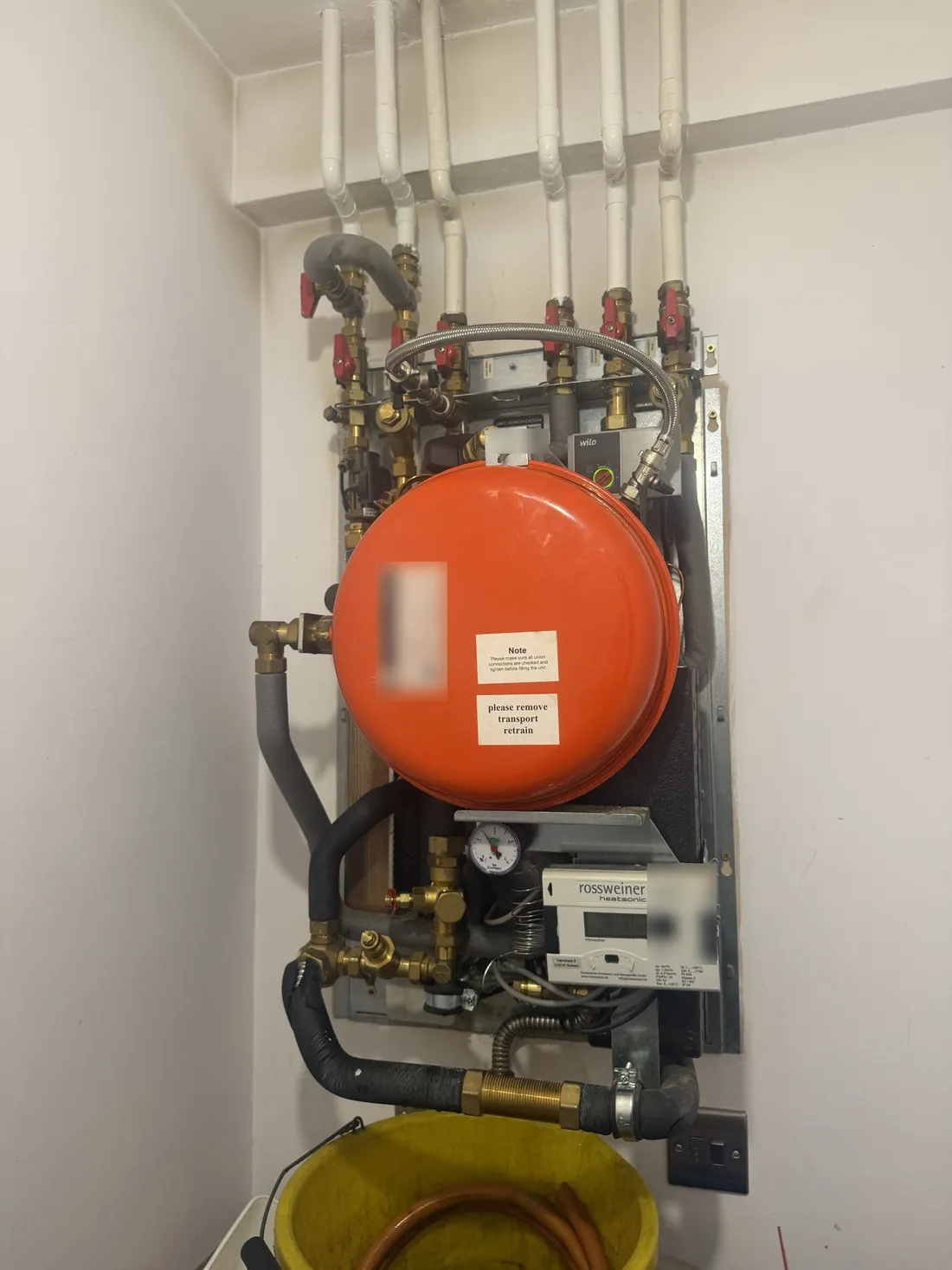 Meibes heat interface unit back together after the repair, with the expansion vessel refitted and the heat meter running