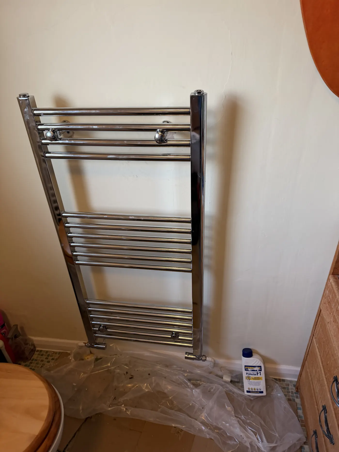 The new chrome ladder towel radiator fitted in the Rowley Regis bathroom, with a bottle of inhibitor beside it