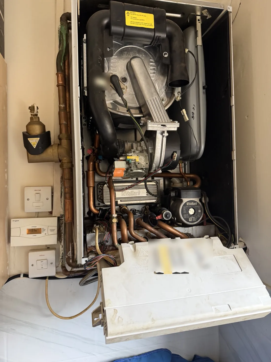 Vaillant ecoTEC pro 28 combi boiler with the case off and the control box lowered during an annual service in Solihull