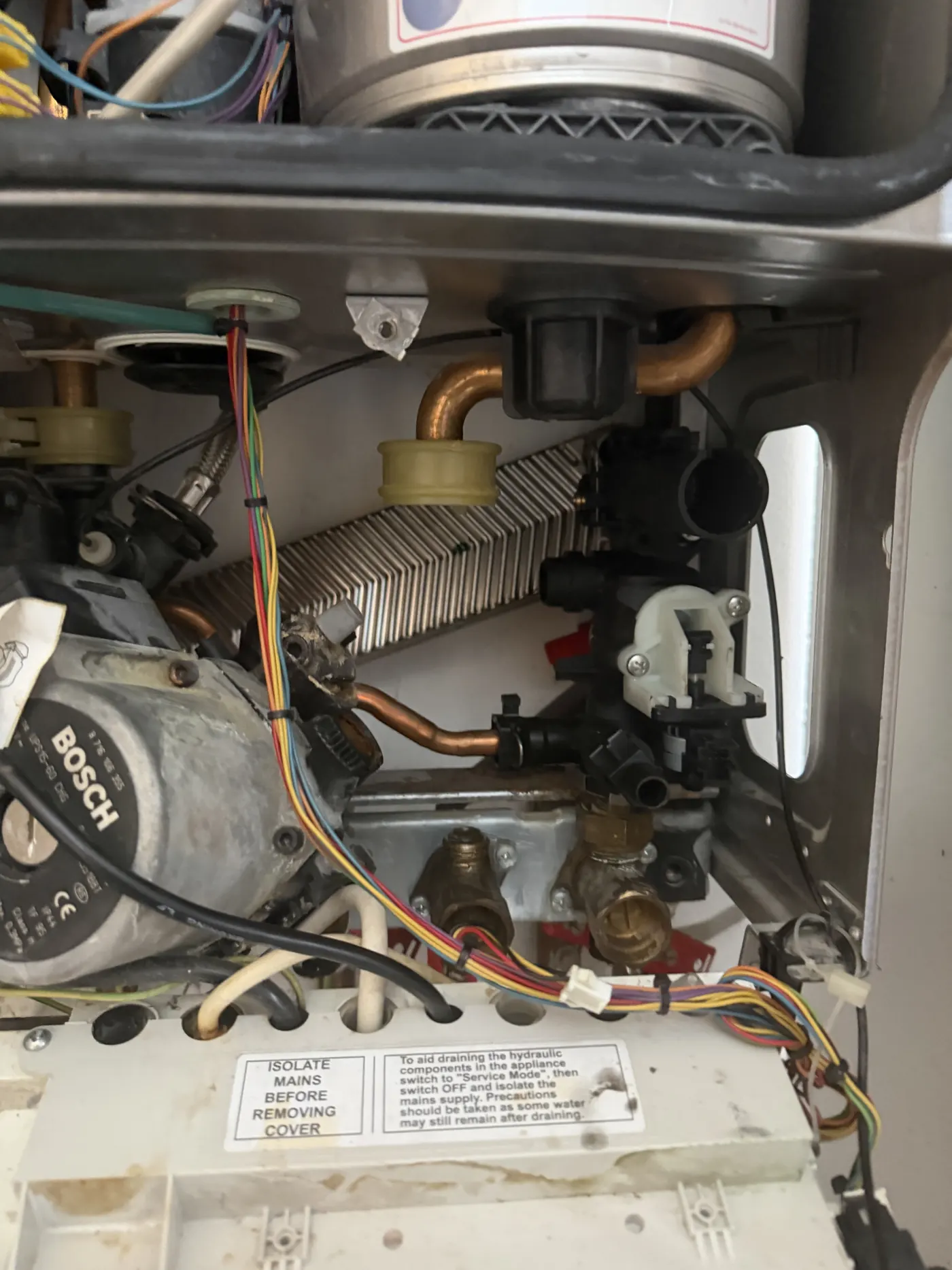 The pump and right-hand hydraulic manifold inside the Greenstar 28i Junior, showing scale around the leaking joints