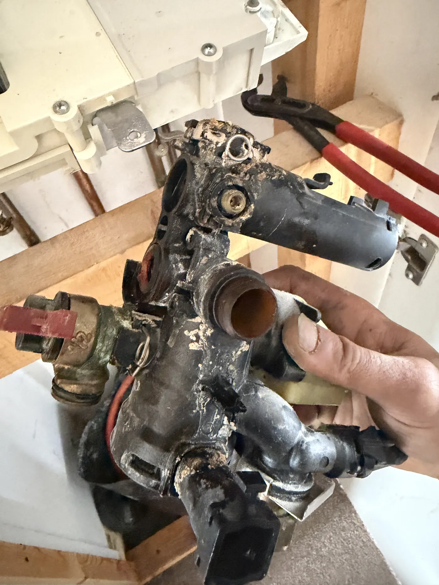 The removed right-hand manifold from the Greenstar 28i Junior, corroded and scaled at the joints