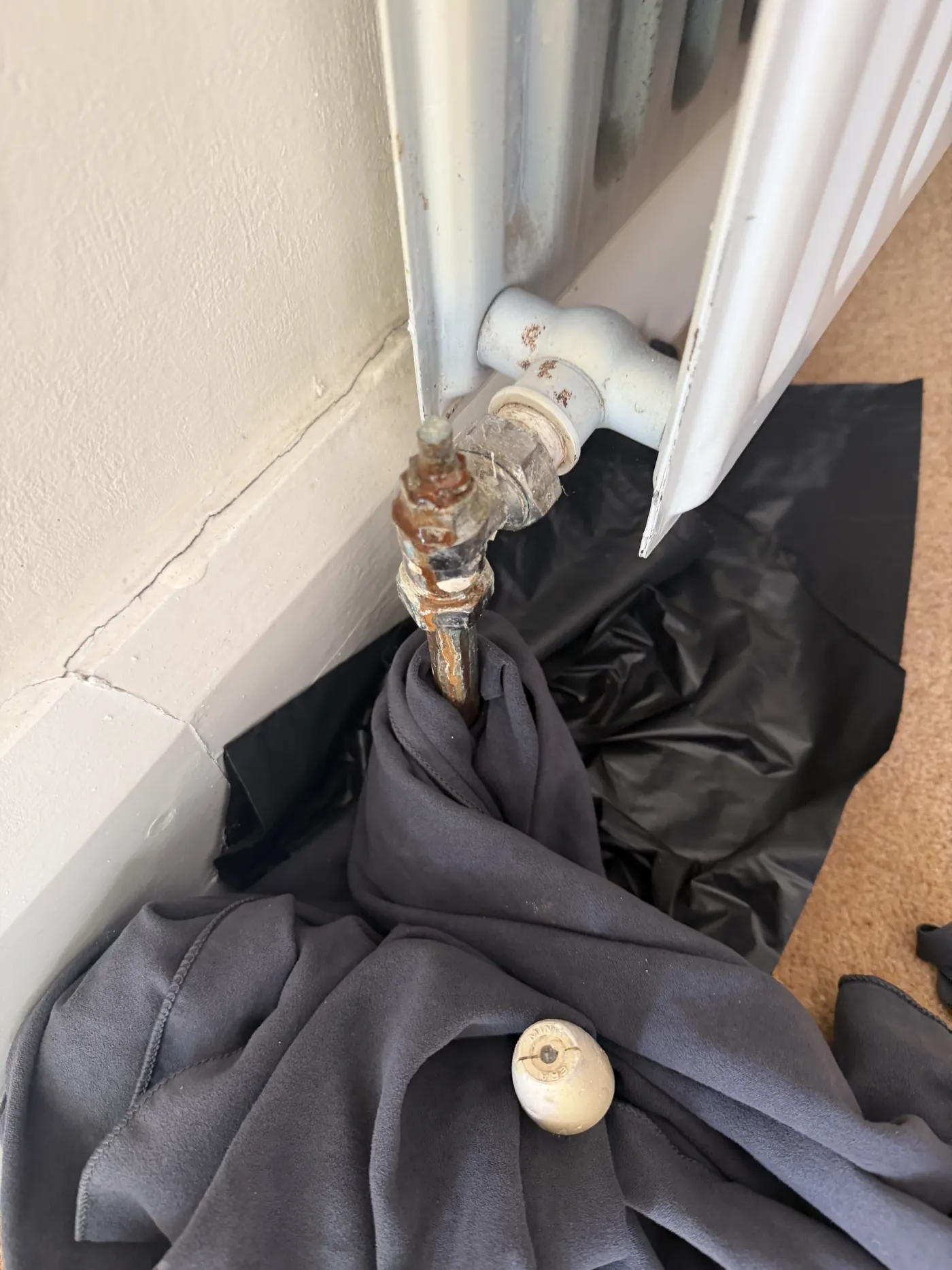 Corroded and leaking radiator valve on a panel radiator in a Sutton Coldfield home