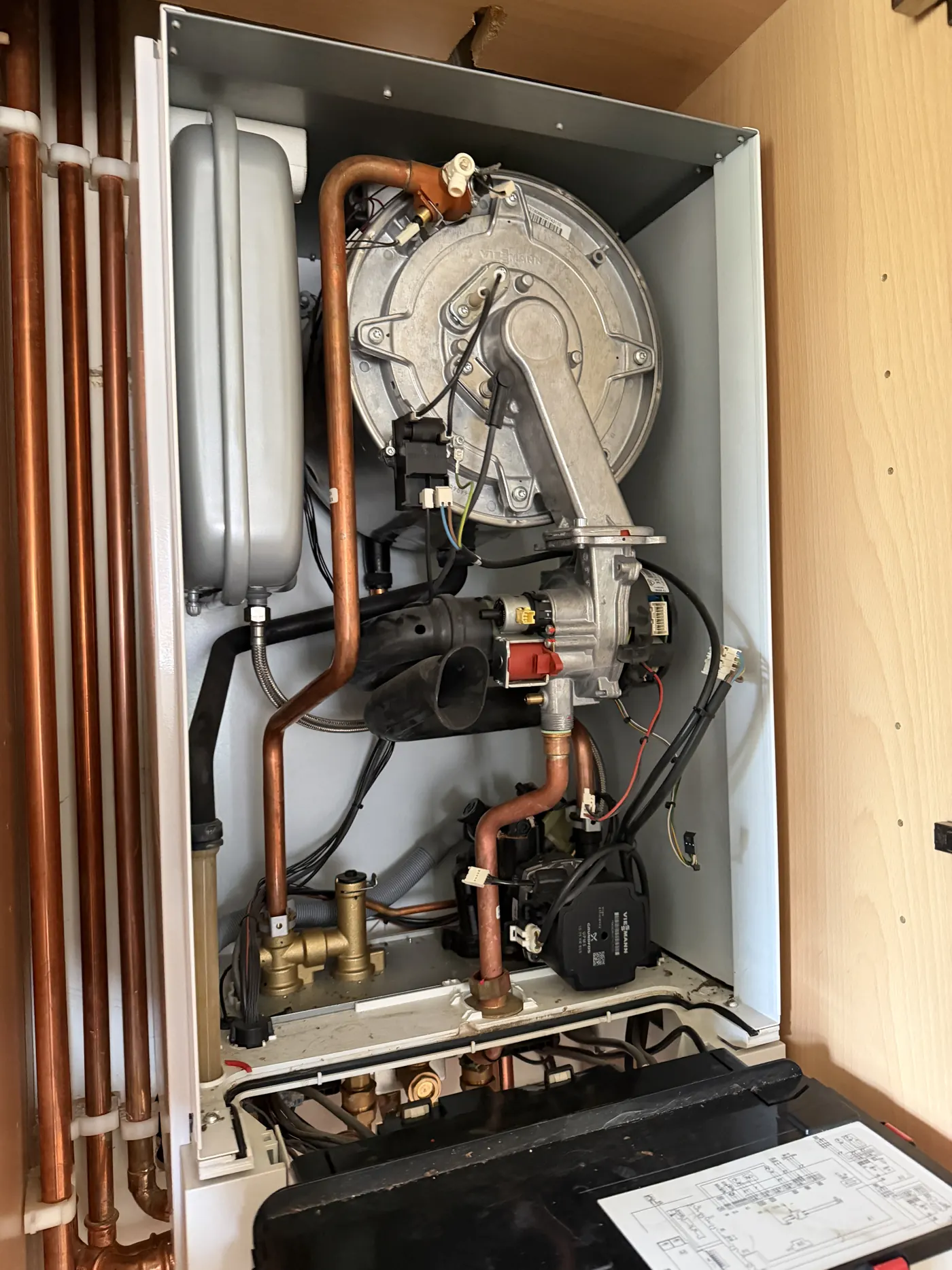 Viessmann boiler in a Sutton Coldfield kitchen cupboard with the case removed before the strip-down service