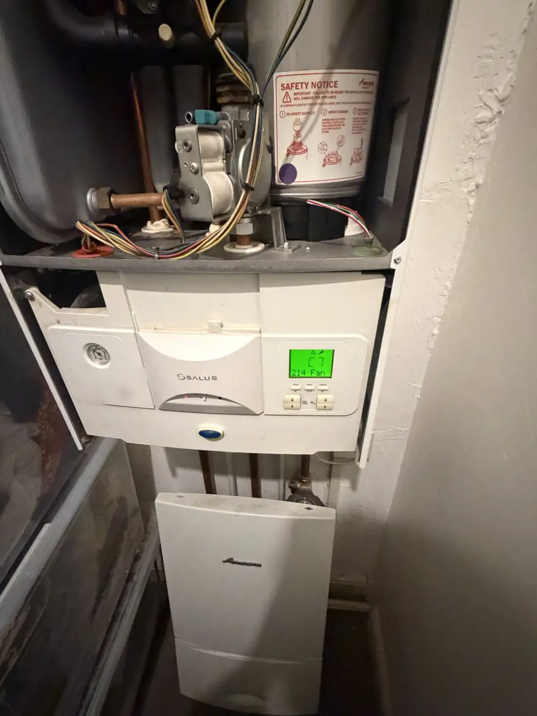 Worcester Greenstar boiler with the front case off, the display showing fault C7 with 214 and Fan