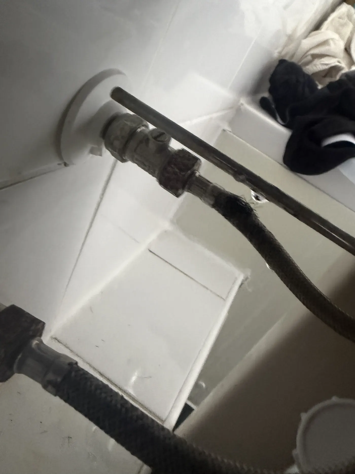 Water dripping from a split flexible tap connector under a basin in a Walsall flat