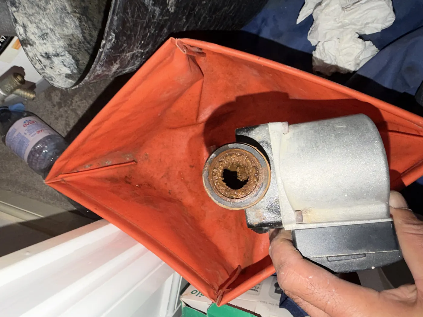 The failed pump removed, with the inlet and impeller housing full of black sludge