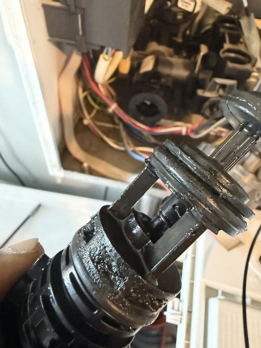 The removed diverter valve cartridge from the Biasi Advance covered in black magnetite sludge