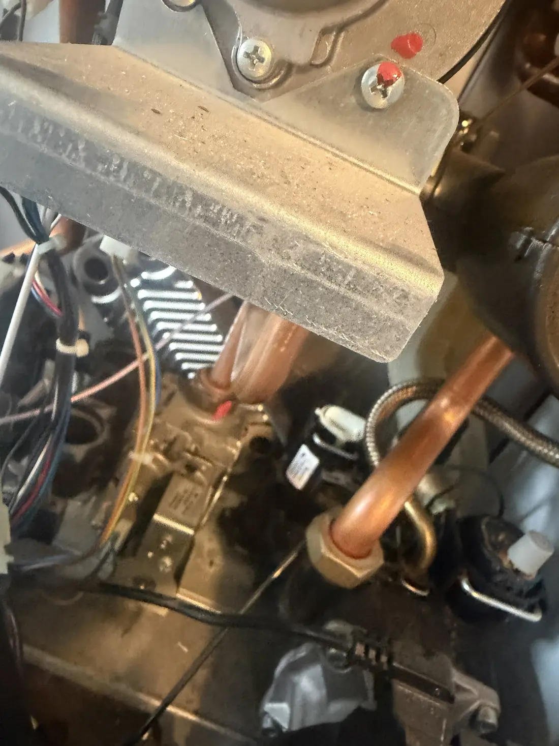 Close-up of the hydraulic block and pipework inside the Biasi Advance where the plate heat exchanger is fitted