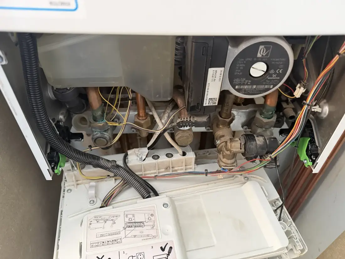 Inside the Worcester Greenstar Compact CDi with the control panel lowered, showing the pump, filter and pipework