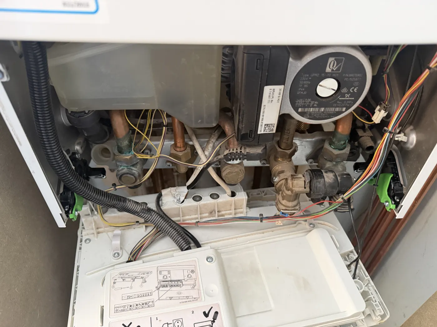 Inside the Worcester Greenstar Compact CDi with the control panel lowered, showing the pump, filter and pipework